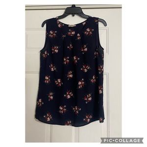 Loft floral sleeveless blouse is a size medium.
